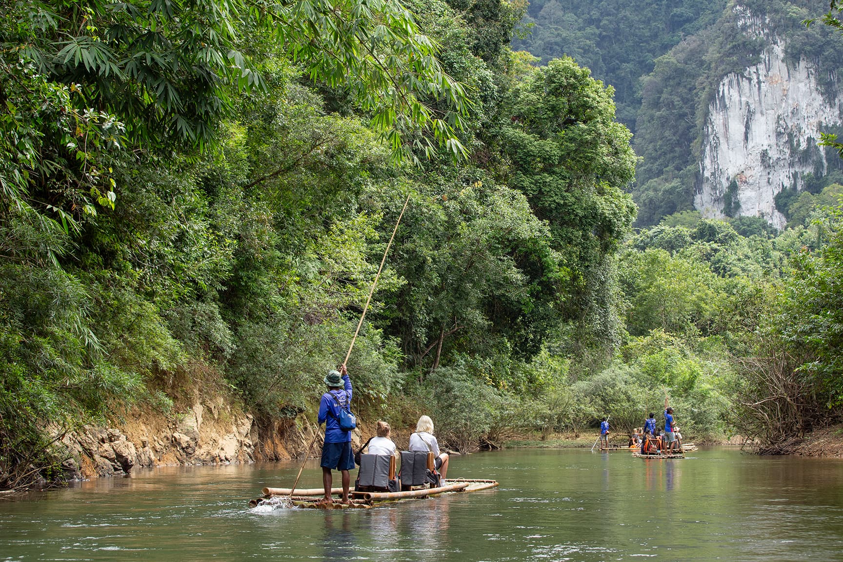 Canoes floating on Cheow Lan Lake with mountians in the background